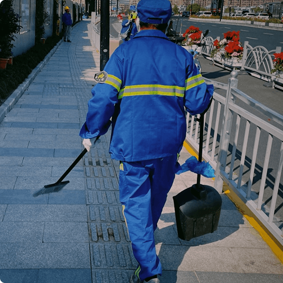 Professional worker in blue uniform power washing